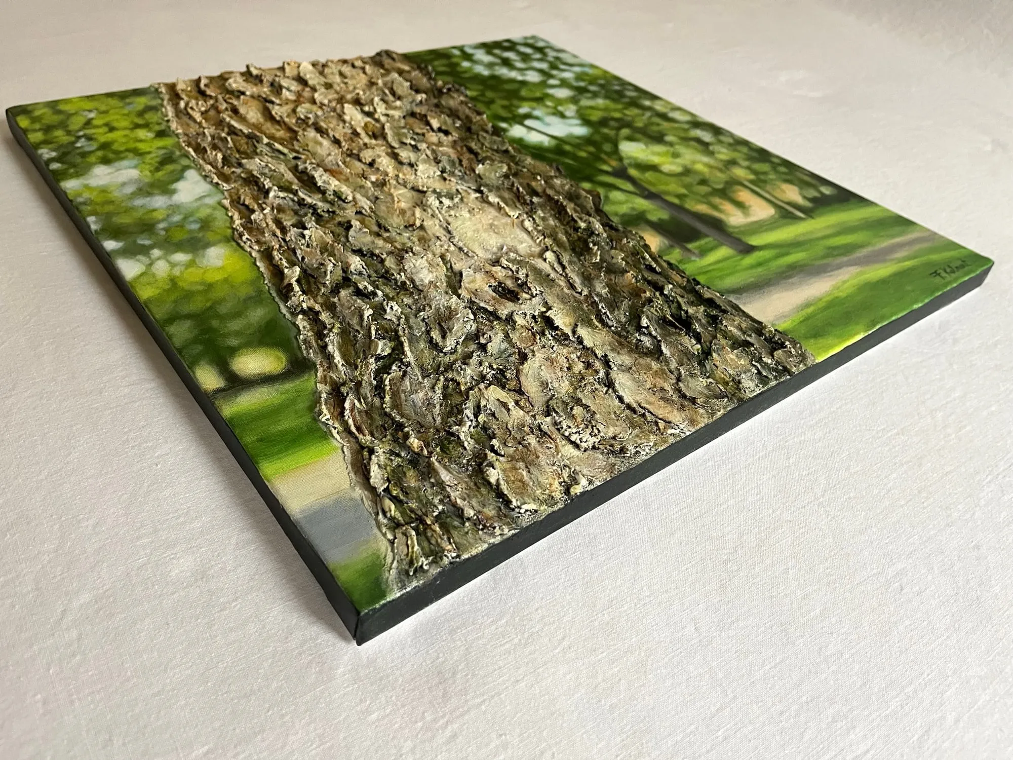 A finished painting photographed at an angle, showing the raised bark texture